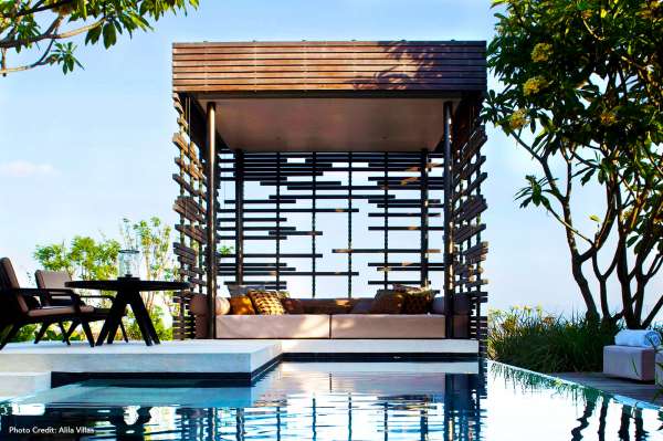 A cabana next to a pool at luxury hotel.