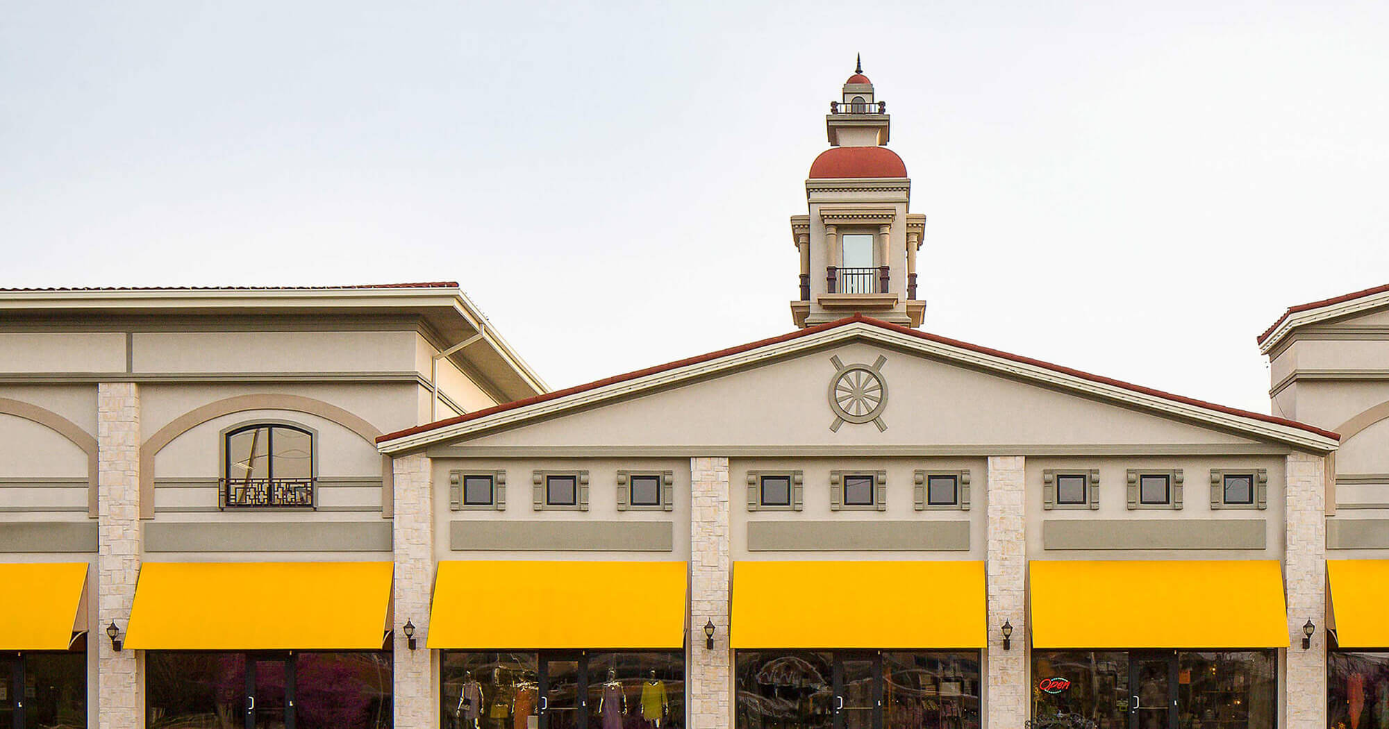 A shopping center gets a pop of color with awnings made using yellow Sunbrella shade fabric