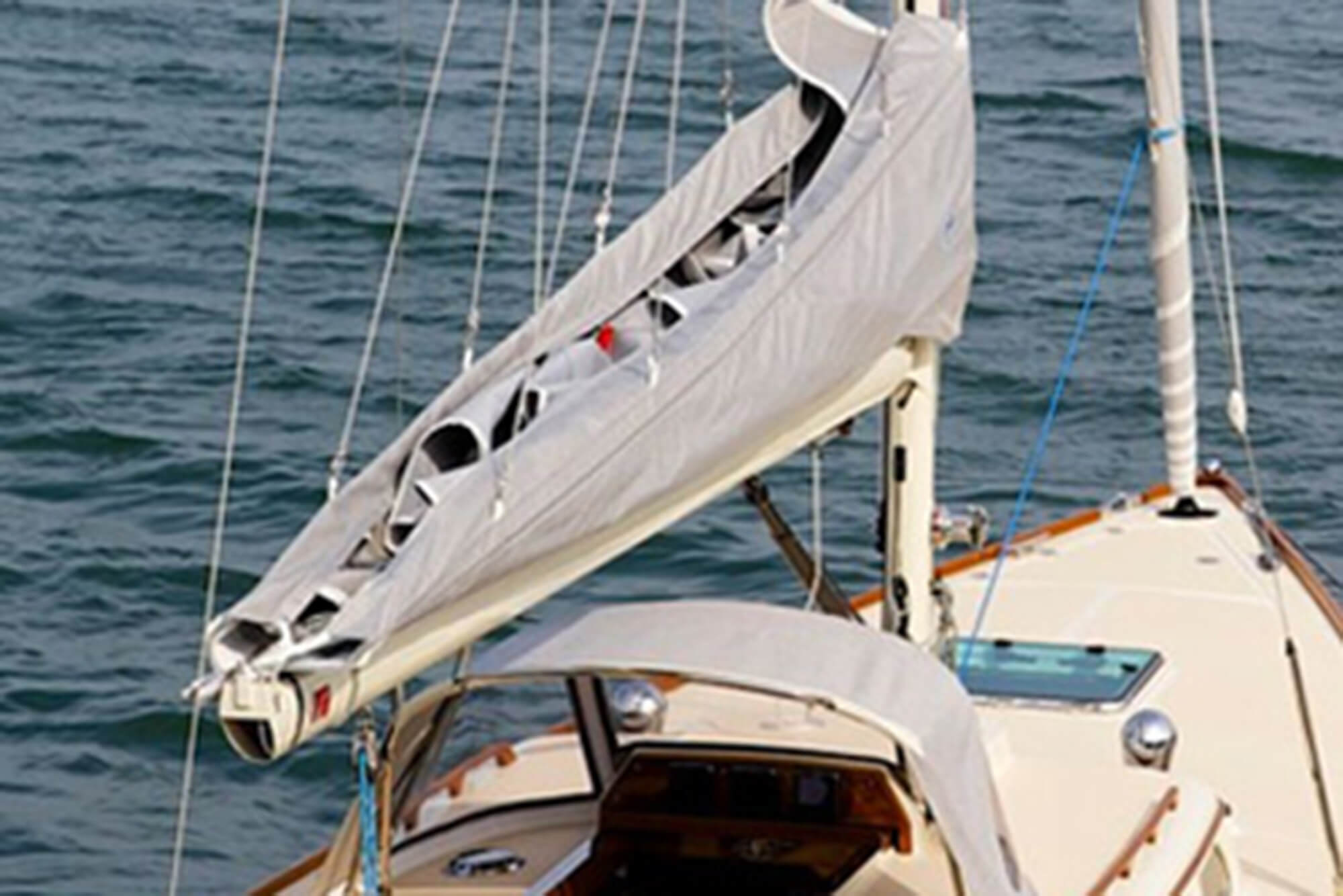 Grå segeltäckning med Sunbrella-tyg som skyddar seglen på en segelbåt