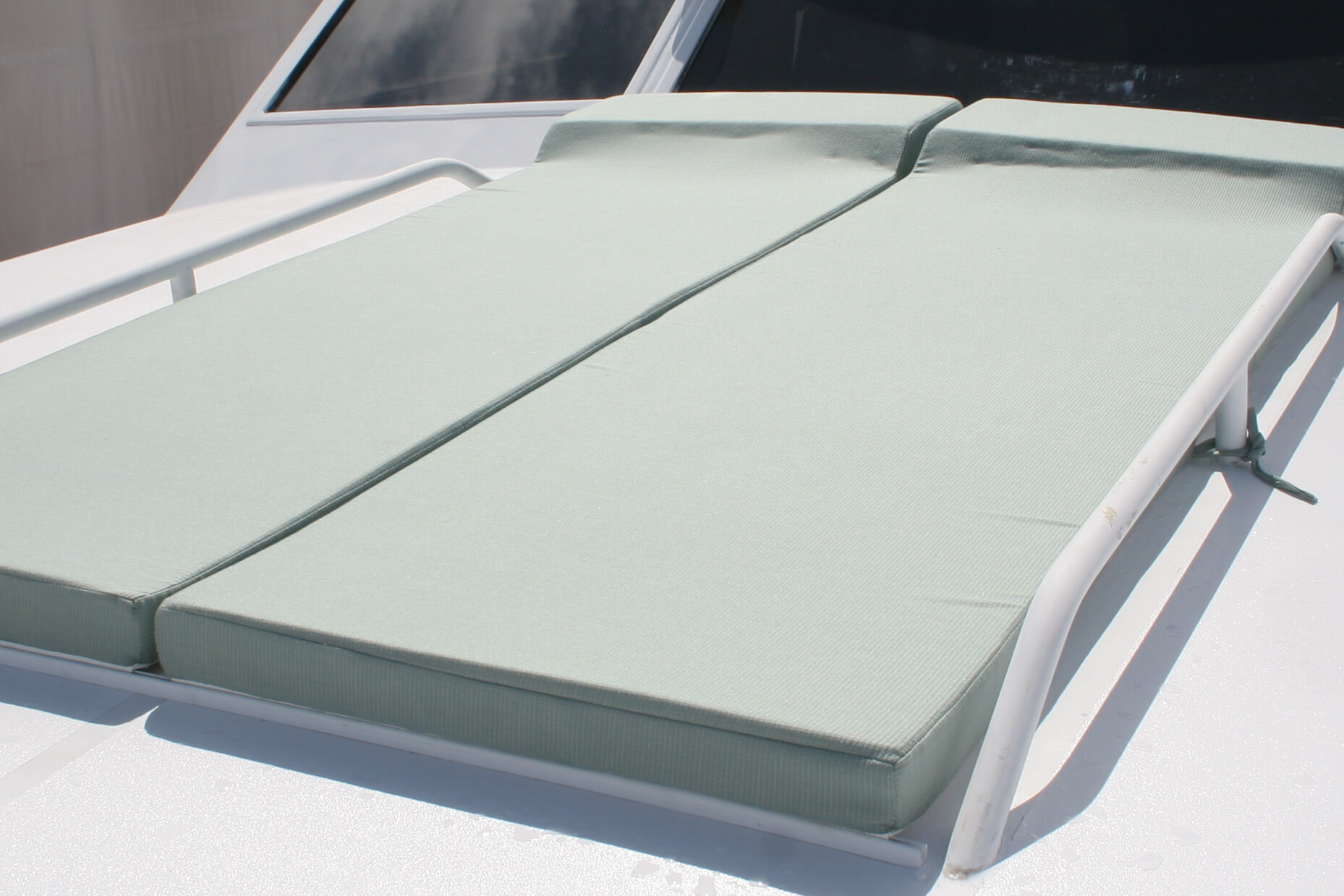 Sunpads covered in Sunbrella fabrics offer a place to enjoy the sun on a boat deck